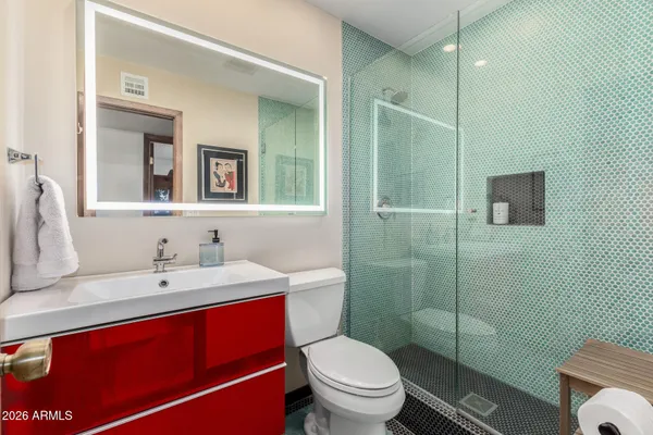 a living room with large pool plants and furniture