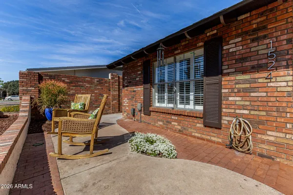 a front view of a house with outdoor seating