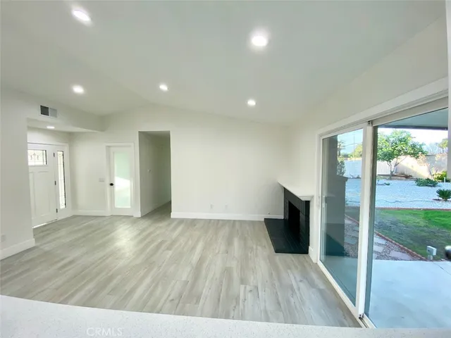 a large kitchen with stainless steel appliances granite countertop a stove a sink dishwasher and a oven with white cabinets