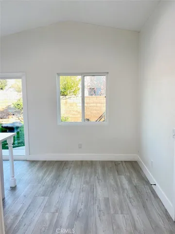 a kitchen with white cabinets stove and sink