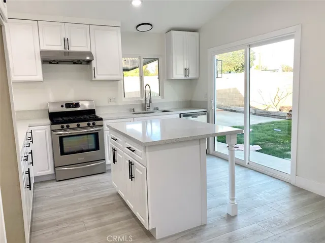 a stove top oven sitting inside of a kitchen