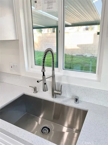 a bathroom with a double vanity sink mirror and bathtub