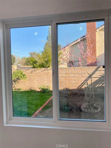 an empty room with wooden floor and entrance