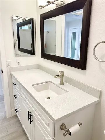 a bathroom with a sink a toilet and mirror