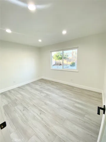 a front view of house with a yard and road