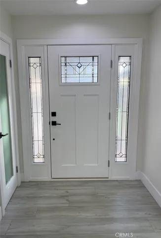 a view of kitchen with kitchen island wooden floor and living room