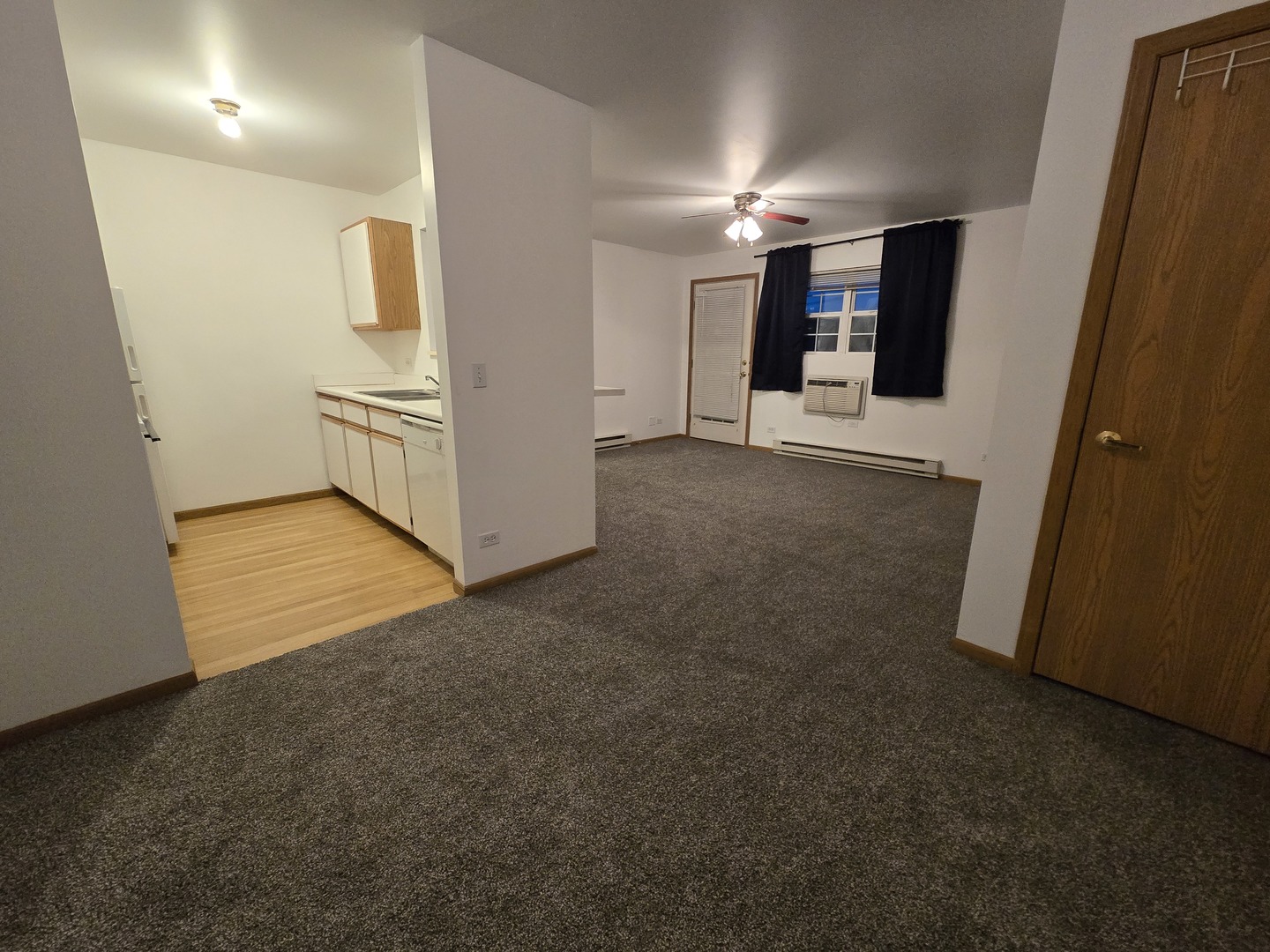 430 Cunat Boulevard, Unit 2A Richmond, IL 60071 - Photo 11 of 13 a view of a hallway with wooden shelves