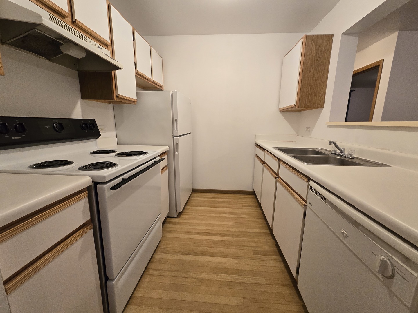 430 Cunat Boulevard, Unit 2A Richmond, IL 60071 - Photo 3 of 13 a kitchen with a sink stove and microwave