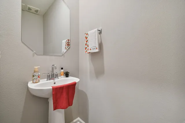 a bathroom with a sink and mirror