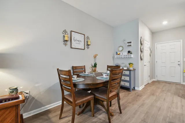 a view of a dining room with furniture and wooden floor