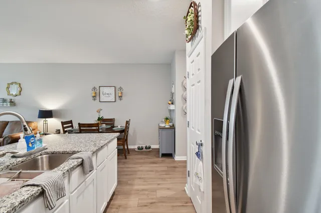 a kitchen with stainless steel appliances granite countertop a refrigerator and a sink