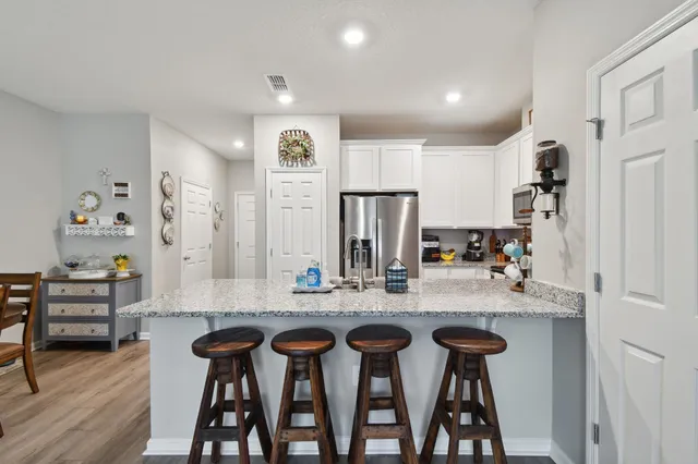 a kitchen with cabinets and chairs