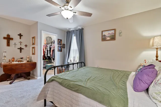 a bedroom with a bed and a chandelier