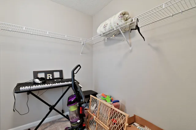 a spacious bedroom with a bed and a chandelier