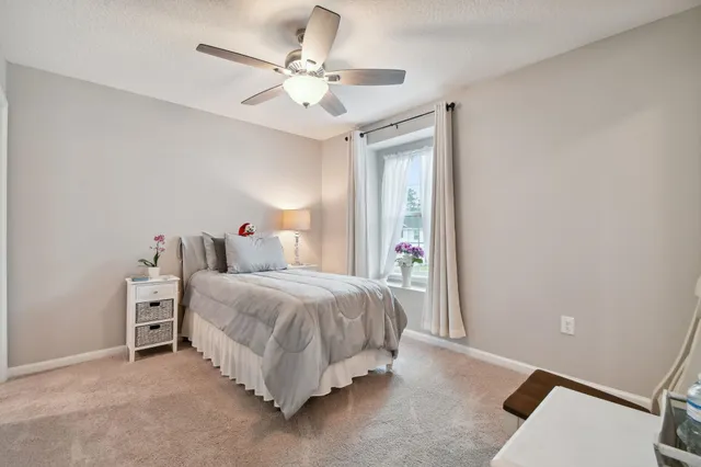 a bedroom with a bed a chandelier and closet
