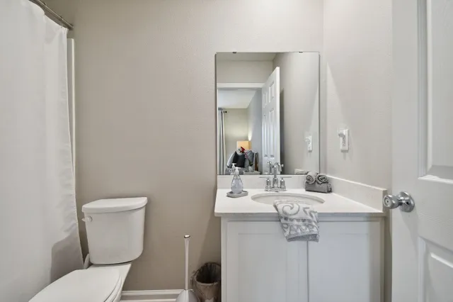 a bathroom with a sink a toilet and mirror