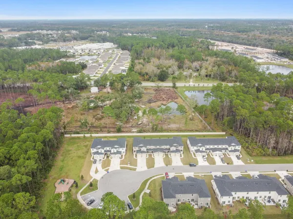 an aerial view of a residential houses with outdoor space