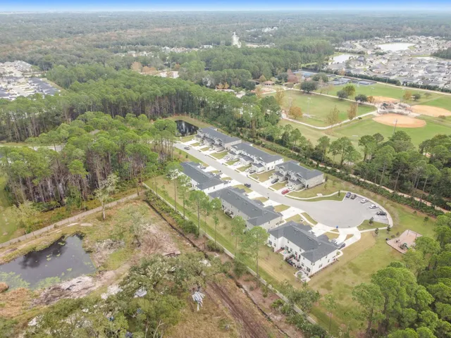 an aerial view of residential houses with outdoor space