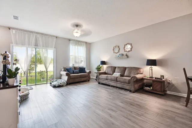 a living room with furniture and a large window