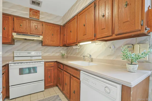a kitchen with a sink cabinets and a window