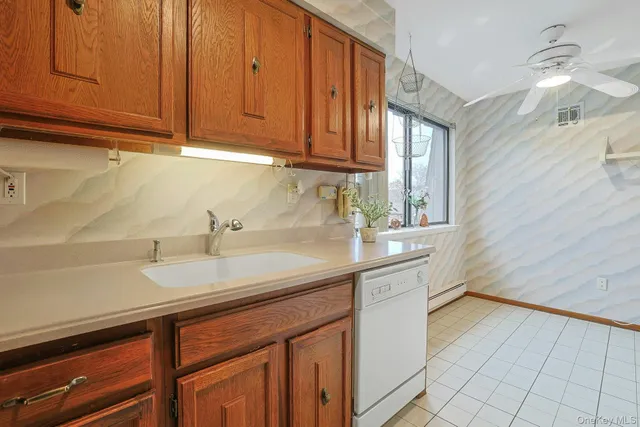 a kitchen with a refrigerator sink and cabinets