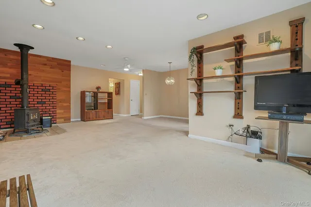 a bathroom with a granite countertop sink a toilet and shower