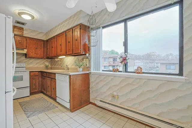 a kitchen with a sink window and cabinets