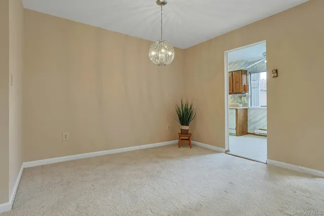 an empty room with windows and painted walls