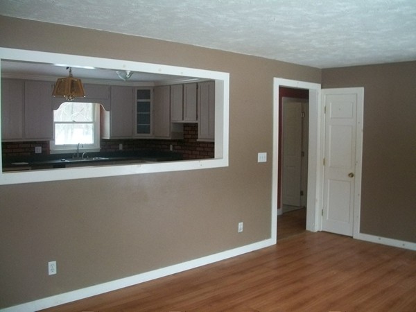 3 Highland Ridge Road Freetown, MA 02702 - Photo 4 of 21 a view of an empty room with wooden floor and a window