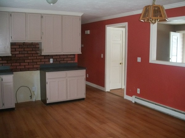 3 Highland Ridge Road Freetown, MA 02702 - Photo 6 of 21 a kitchen with granite countertop white cabinets and wooden floor