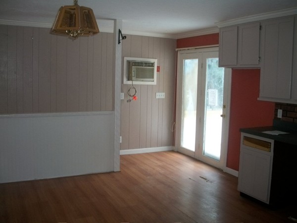 3 Highland Ridge Road Freetown, MA 02702 - Photo 8 of 21 an empty room with wooden floor and cabinets