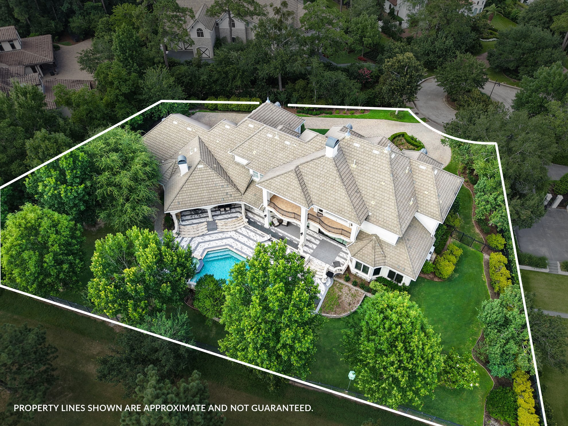 39 Maymont Way Spring, TX 77382 - Photo 50 of 50 This aerial view showcases a spacious, luxurious home with a large multi-level roof, surrounded by lush greenery. The property includes a beautifully designed swimming pool and well-maintained landscaping, offering privacy and elegance.