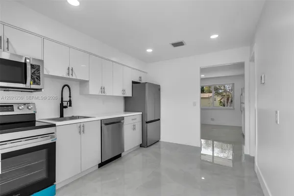 a kitchen with a sink stainless steel appliances and cabinets