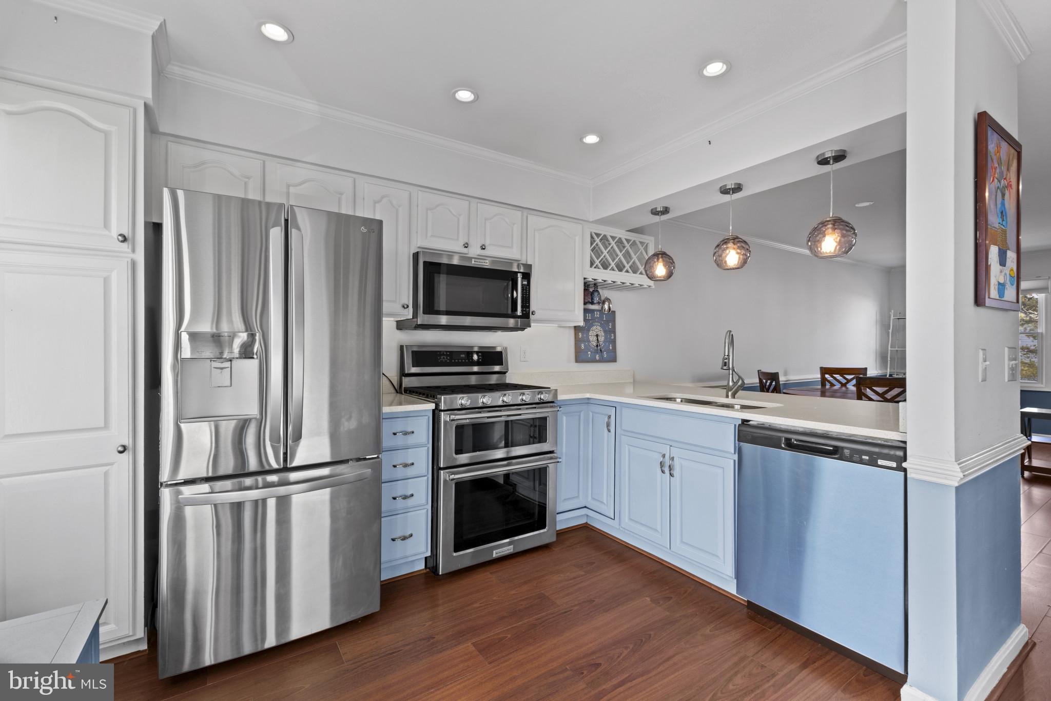 204 Ring Neck Court Chester, MD 21619 - Photo 13 of 29 a kitchen with cabinets stainless steel appliances and wooden floor