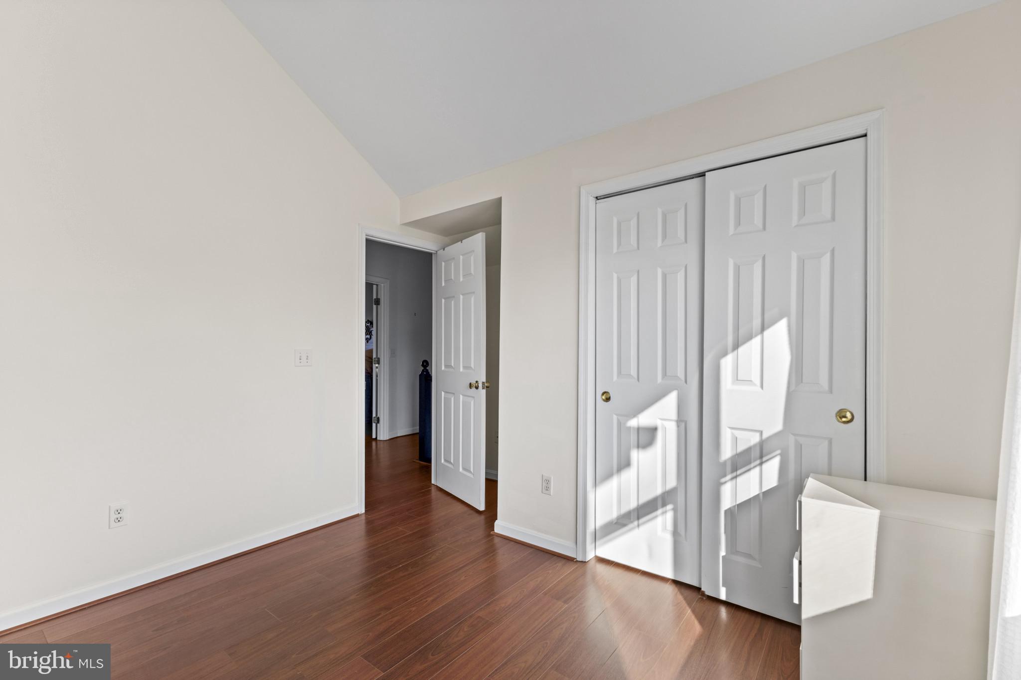 204 Ring Neck Court Chester, MD 21619 - Photo 16 of 29 a view of an empty room with wooden floor and a window