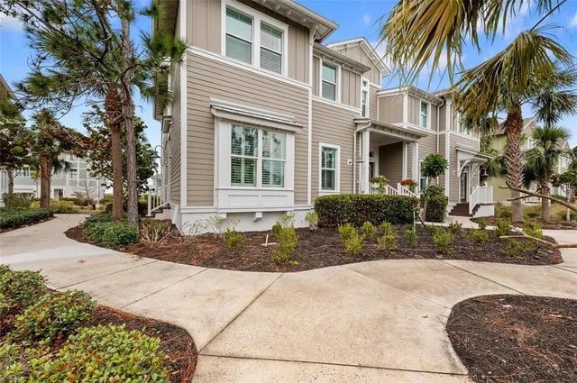 a living room with furniture a fireplace and a chandelier