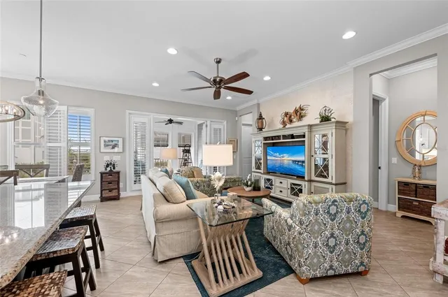 a kitchen with stainless steel appliances granite countertop a stove top oven a sink dishwasher a dining table and chairs with wooden floor