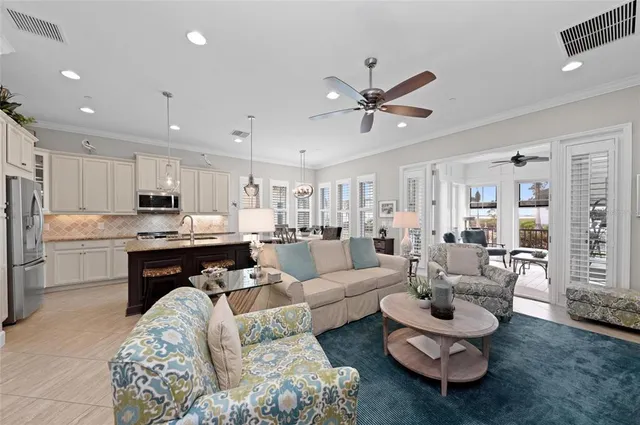 a large kitchen with granite countertop lots of counter top space and stainless steel appliances