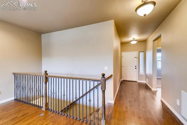 a view of hallway with wooden floor
