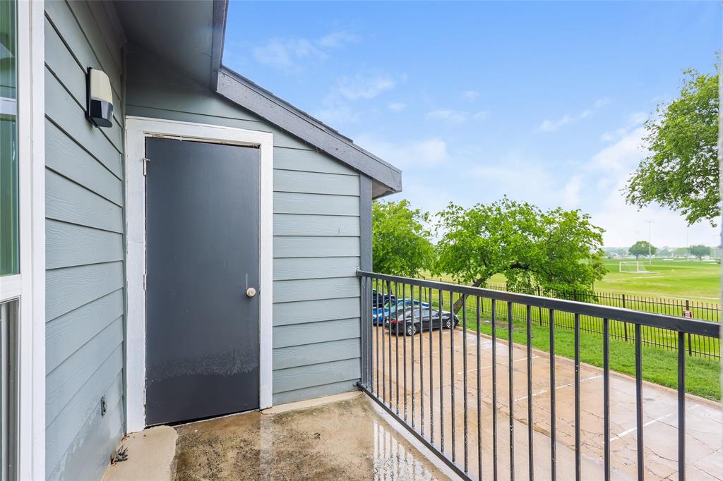 9696 Walnut Street, Unit 1216 Dallas, TX 75243 - Photo 18 of 19 Private balcony featuring grey siding, a black metal railing, and an outdoor light fixture