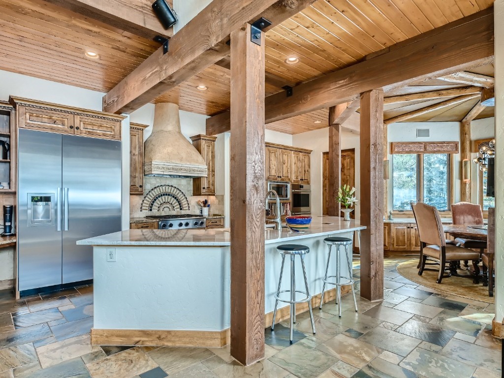 1817 Falcon Drive Silverthorne, CO 80498 - Photo 11 of 37 a kitchen with stainless steel appliances granite countertop a stove and a refrigerator