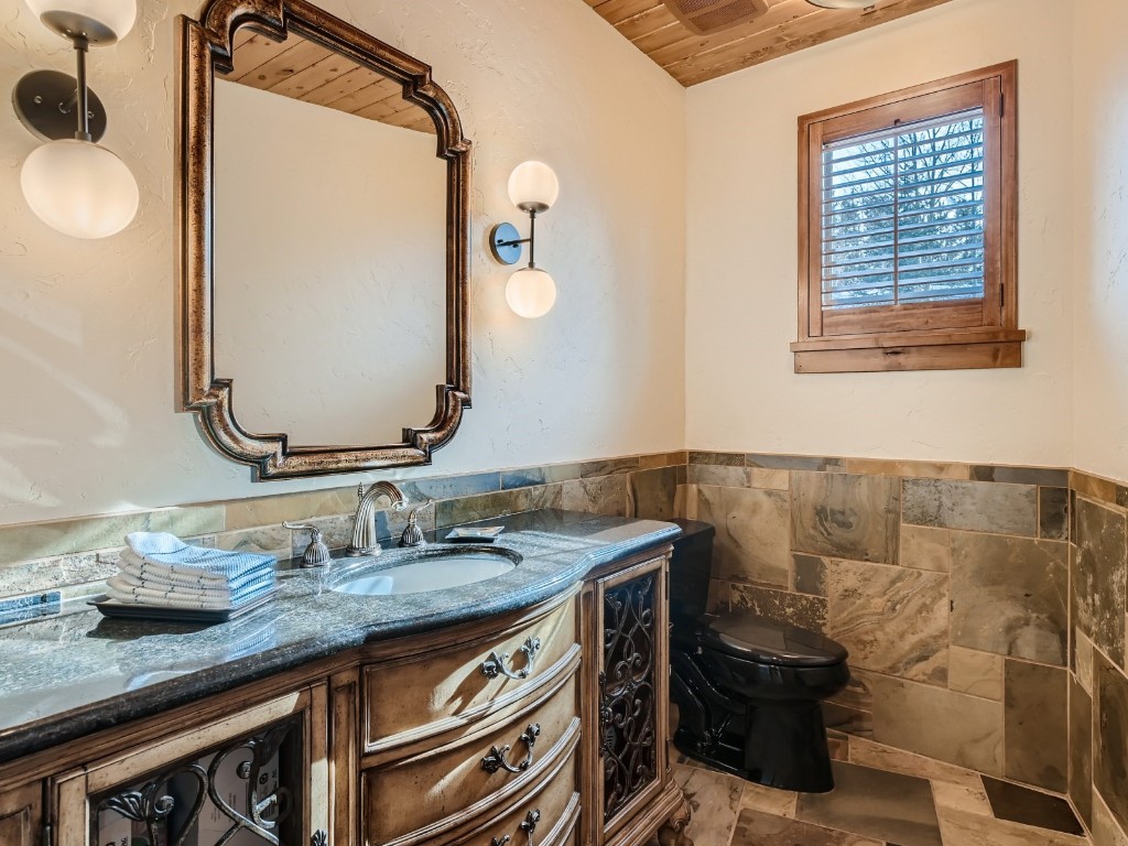 1817 Falcon Drive Silverthorne, CO 80498 - Photo 14 of 37 a bathroom with a granite countertop sink a mirror and a