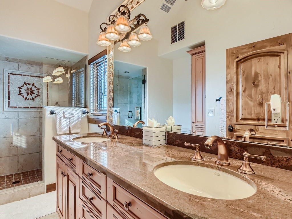 1817 Falcon Drive Silverthorne, CO 80498 - Photo 24 of 37 a bathroom with double vanity sinks a vanity a lamp and a mirror