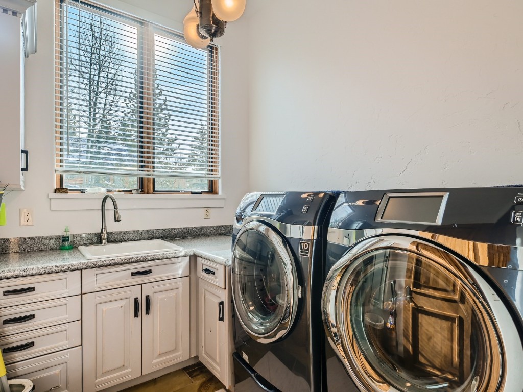 1817 Falcon Drive Silverthorne, CO 80498 - Photo 35 of 37 a utility room with stainless steel appliances granite countertop a sink and a window