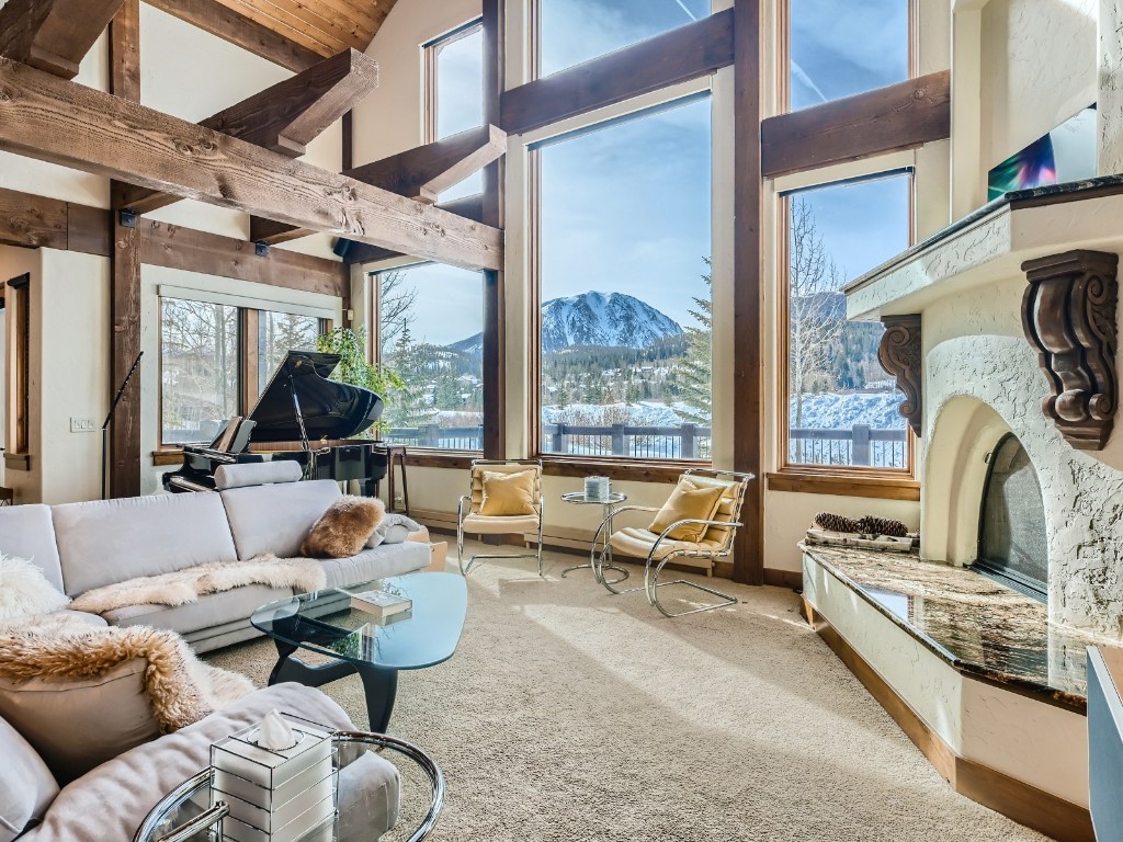 1817 Falcon Drive Silverthorne, CO 80498 - Photo 5 of 37 a living room with furniture fireplace and a large window
