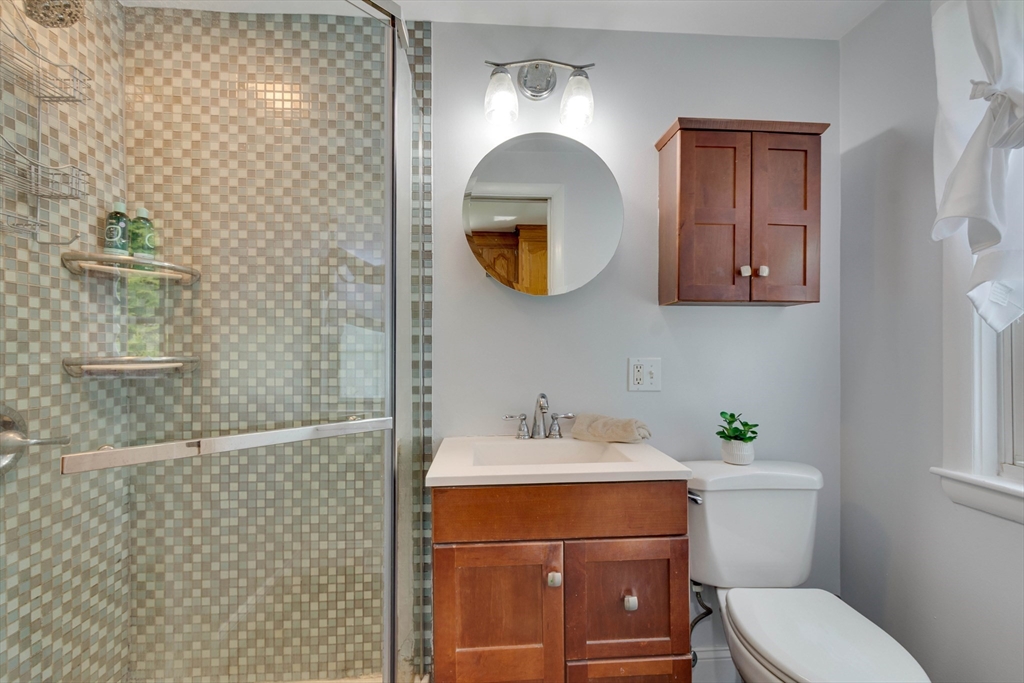 15 Williams Road North Reading, MA 01864 - Photo 20 of 38 a bathroom with a toilet a sink and mirror