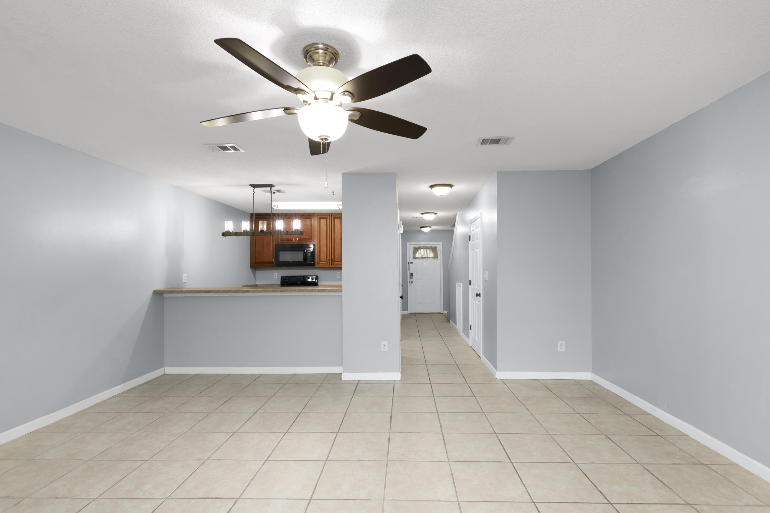 501 Keystone Road Mary Esther, FL 32569 - Photo 13 of 36 en empty room with wooden floor and ceiling fan