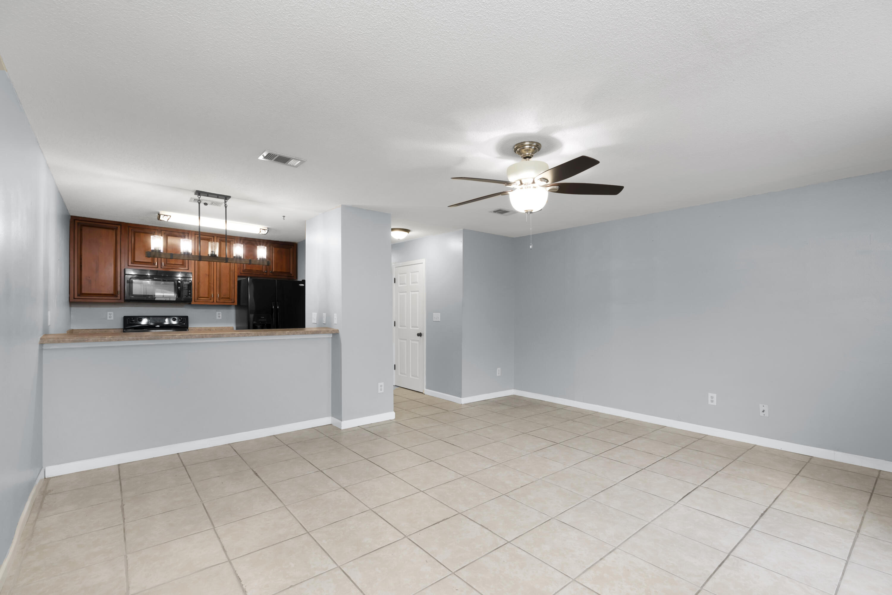 501 Keystone Road Mary Esther, FL 32569 - Photo 14 of 36 a view of an empty room and a kitchen