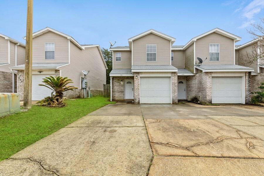 501 Keystone Road Mary Esther, FL 32569 - Photo 36 of 36 a front view of a house with a garden and yard
