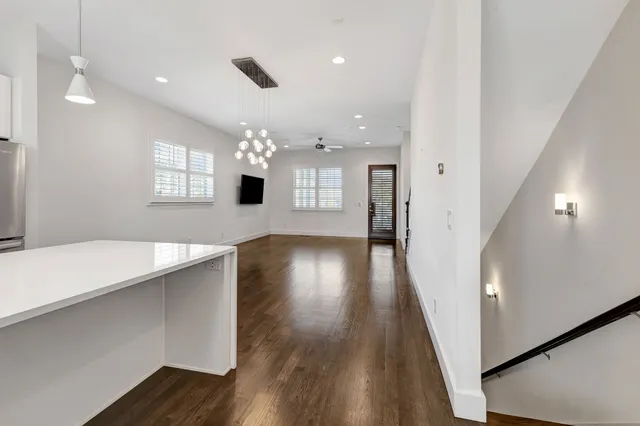 a view of a room with wooden floor and staircase